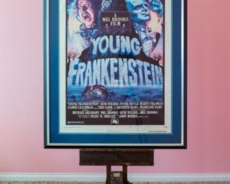 1974 Young Frankenstein movie poster, Style B. 74/249. NOTE: Tripod reflection in photo.  Professionally framed by Sherman Gallery, Venice, California.  Artwork under mat board is larger than what is visible. Visible artwork measures 26 ¾ x 40  ¾”. Frame measures  34 ¾ x 48 ¾. Starring Gene Wilder & Peter Boyle. Cult-classic film directed by Mel Brooks. 