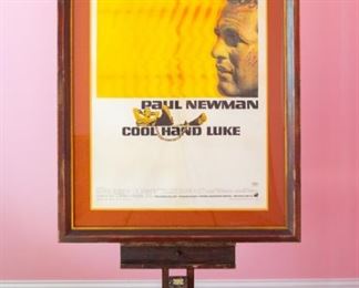 Cool Hand Luke movie poster 1967 starring Paul Newman 67/307.  Tripod reflection in photo. Artwork under mat board is larger than what is visible. Visible artwork measures 27 ¼"x 40 ⅜ ". Frame measures 37 ½  x 40 ¾. Artist for this poster was James Bama, under the art direction of Bill Gold.