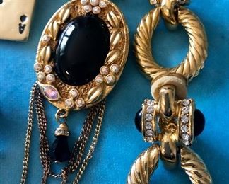 Jewelry Group X                                                                                              Kenneth J Lane brooch, black with hanging chains $45.00                                                                                                                     Signed own pin $14.00                                                                                   Marcasite coach pin $14.00                                                                         Symbol necklace $14.00                                                                             Weiss Vintage blue rhinestone pin $24.00