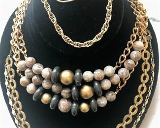 Jewelry #18                                                                                                       Gold tone chain with brownish beads, $22.00                            Foster 1/20 gold filled ID bracelet $22.00                                        Gold tone tie clasp with chain detail $14.00                                 Gold tone circle necklace $18.00