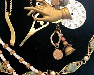 Jewelry #12                                                                                                              Gold tone bracelet with green stones $20.00                               Artisan made clock necklace $14.00                                                   Gold tone necklace with curvy bar pendant $14.00                   Gold tone bar necklace $14.00                                                                  Vintage Les Bernard 1980's white and gold tone necklace $18.00
