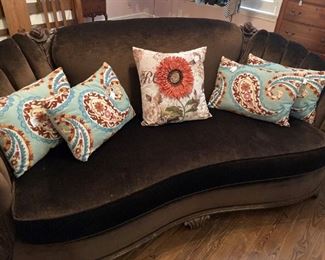 Curved back antique sofa; decorative pillows sold separately 