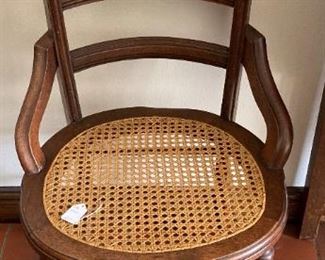 One of two cane seat chairs