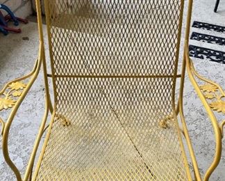 One of two yellow patio chairs
