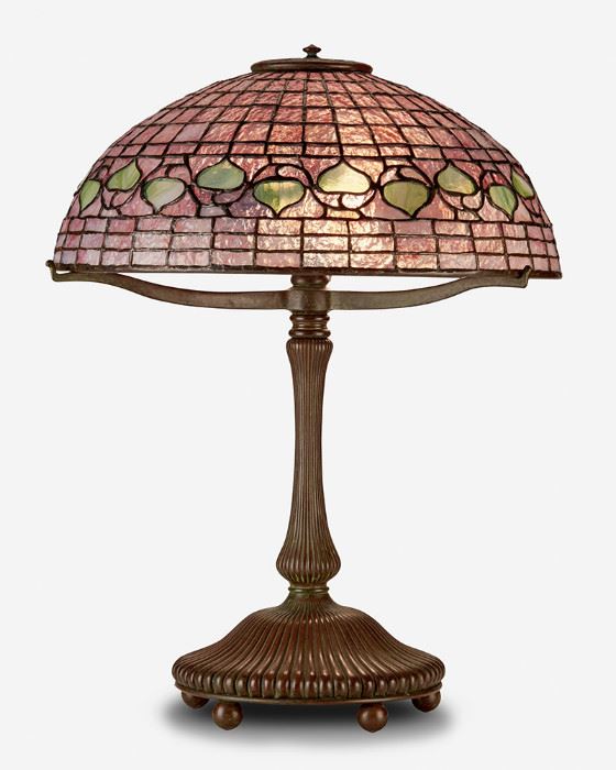 1
A Tiffany Studios "Acorn" Table Lamp
Circa 1902-1919; New York, NY
Base spuriously signed: Tiffany Studios / New York / 28622
The pink and green leaded glass "Acorn" shade on a three-light patinated bronze Tiffany-style reproduction mushroom base with flared column raised on five ball feet, electrified
Overall: 21.5" H x 16" Dia.
Estimate: $4,000 - $6,000