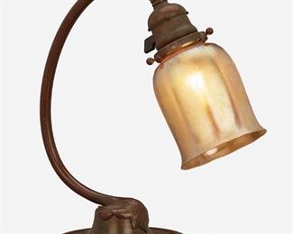 6
A Tiffany Studios Table Lamp
Circa 1902-1919; New York, NY
Shade signed: L.C.T.; Base signed: Tiffany Studios / New York / 637
The gold iridescent Favrile glass floriform shade on a patinated bronze gooseneck base with adjustable head, curving stem, and circular foot with leaf motif, electrified
12" H x 6.125" W x 7" D
Estimate: $1,000 - $2,000