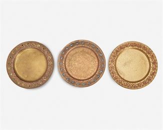 26
Three Louis C. Tiffany Furnaces Bronze And Enamel Chargers
Circa 1919-1928; New York, NY
Each signed: Louis C. Tiffany Furnaces, Inc. / [L.C.T. monogram] / Favrile / 309
Each patinated and gilt-bronze charger with foliate and Greek key meander border set with monochrome enamel jewels in red, green, and blue raised on five flattened ball feet, 3 pieces
Each: .625" H x 8.25" Dia.
Estimate: $400 - $600