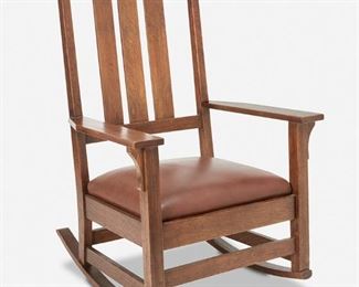 39
A Gustav Stickley Oak Rocking Chair, No. 397
Circa 1901-1916; Eastwood, NY
Stickley shop mark [joiner's compass]
The original finish oak tall back rocking chair with three slats and corbeled arms over a brown leather seat atop four square legs with rockers joined by a box stretcher
43" H x 27" W x 29" D
Estimate: $800 - $1,200
