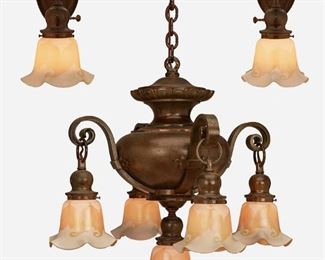 44
A Patinated Bronze Chandelier With Sconces
First-quarter 20th Century
Each shade signed: Quezal
The five-light patinated metal chandelier with a pinched neck, gadrooned border, and rotund body issuing four scrolled arms terminating in drop pendants and one central pendant each with a white Quezal glass shade with iridescent gold interior, pulled feather motif, and ruffled rim and fitted overall with flared canopy and chain link harness, accompanied by two matching wall sconces, electrified, 3 pieces
Chandelier: 30.5" H x 21" Dia.; Each sconce: 12" H x 6" Dia.
Estimate: $1,000 - $2,000