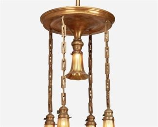 43
A Gilt-Metal Chandelier With Steuben Aurene Glass Shades
Second-quarter 20th Century
Each shade signed: Steuben
The gilt-metal chandelier with flared canopy issuing four drop pendants on square chain link harnesses and one central light, each with an iridescent gold Aurene glass floriform shade, electrified
44" H x 20" Dia.
Estimate: $800 - $1,200