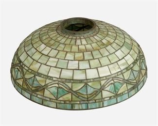 50
A Duffner And Kimberly Leaded Glass Hanging Shade
First-quarter 20th Century; New York, NY
Unsigned
The leaded glass domed shade with green and amber mottled slag glass geometric patterning and stylized vine border with verdigris patinated bronze fitter ring
8.75" H x 24" Dia.
Estimate: $2,500 - $3,500