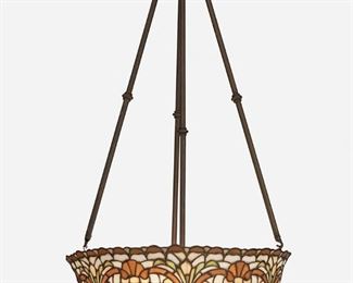 52
An Arts And Crafts Leaded Glass Chandelier
First-quarter 20th Century
Possibly Duffner and Kimberly, the domical leaded glass shade with scrolling floral motifs in amber, yellow, green, and white with a scalloped rim and fitted with three lights and four patinated metal hanging shafts, electrified
38" H x 20.5" Dia.
Estimate: $1,500 - $2,500
