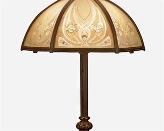 59
An Arts And Crafts Reverse-Painted Table Lamp
First-quarter 20th Century
Appears unmarked
Likely Bradley & Hubbard, the hexagonal shade with six ribbed glass panels with reverse-painted floral motif set in a bronze frame atop a two-light patinated bronze base with ribbed column raised on a square foliate motif foot, electrified
Overall: 22" H x 16" Dia.
Estimate: $700 - $900