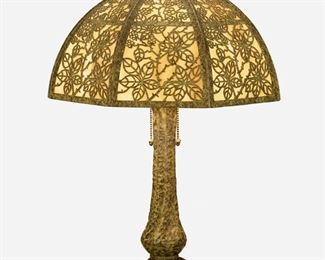 58
A Bradley & Hubbard Arts And Crafts Table Lamp
First-quarter 20th Century; Meriden, Connecticut
Base signed: B&H / 154
The verdigris patinated metal lamp with an octagonal shade with yellow and white slag glass panels and rose vine motif metal overlay on a four-light tapered base with ribbed column, inverted floriform foot, acorn pulls, and acorn finial, electrified
Overall: 25" H x 15.125" Dia.
Estimate: $600 - $800