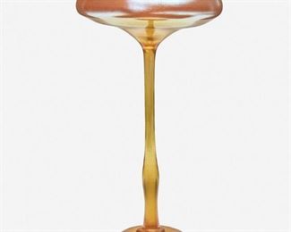 74
A L.C. Tiffany Favrile "Prince" Compote
1905; New York, NY
Signed: L.C.T. / W 7749
The gold iridescent compote with a shallow, flared basin raised on a slender stem
11" H x 5.5" Dia.
Estimate: $600 - $800