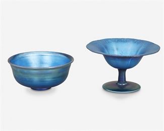 76
Two Blue L.C. Tiffany Favrile Glass Items
Circa 1892-1893; New York, NY
First signed: L.C. Tiffany / Favrile / 1700; Second signed: L.C. Tiffany / Favrile / 1236
Each blue iridescent Favrile glass, comprising one compote with onion skin rim and ribbed exterior and one footed bowl with flared lip, 2 pieces
Larger: 3" H x 5.25" Dia.; Smaller: 2.25" H x 4.875" Dia.
Estimate: $500 - $700