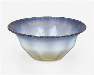 78
A L.C. Tiffany Blue Opalescent Favrile Glass Bowl
Late 19th/early 20th Century; New York, NY
Signed: Favrile
The opalescent Favrile glass bowl with a flared, blue onion skin rim fading to a clear ribbed base with an opaque white transition
3.5" H x 8.25" Dia.
Estimate: $500 - $700
