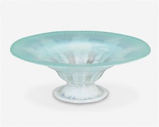 80
A L.C. Tiffany Blue Opalescent Favrile Glass Compote
Circa 1902-1919; New York, NY
Signed: L.C. Tiffany / Favrile / 1848 / [L.C.T. monogram paper label]
The opalescent Favrile glass compote with an aqua blue-colored onion skin flared rim fading to light green with radiating opaque white stripes raised on an opaque white foot
3.75" H x 10.25" Dia.
Estimate: $400 - $600
