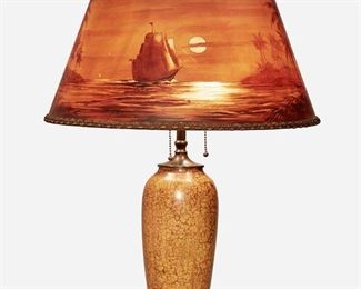 83
A Handel Reverse-Painted Parchment "Treasure Island" Table Lamp
First-quarter 20th Century; Meriden, Connecticut
Shade signed: Broggi; Base marked: 1219
The table lamp with a tapered drum-shaped parchment shade with reverse-painted nautical scene depicting a sailing vessel in a moonlit tropical bay with palm tress, in shades of umber and ochre, with ribbon trim on a three-light base with a baluster-form iridescent orange glazed ceramic body with crazed finish raised on a circular patinated metal foot and surmounted by an openwork finial, electrified
Overall: 25" H x 18" Dia.
Estimate: $1,000 - $1,500