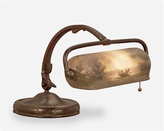 85
A Handel Painted Glass Landscape Piano Lamp
First-quarter 20th Century; Meriden, Connecticut
Shade signed: Handel / 6253; Base signed: Handel
The pivoting cylindrical chipped ice finished glass shade with obverse and reverse-painted wooded landscape scene on a single-light patinated metal base with adjustable gooseneck arm raised on a circular foot, electrified
Overall: 13.5" H x 12.5" W x 8.5" D
Estimate: $800 - $1,200