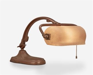 86
A Handel Acid-Etched Glass Piano Lamp
First-quarter 20th Century; Meriden, Connecticut
Shade signed: Handel / Brown / 6132 1/2; Base signed: Handel [cloth label]
The pivoting cylindrical acid-etched glass shade with caramel-colored pine needle motif on a single-light patinated metal base with adjustable gooseneck arm raised on an ovoid foot, electrified
15" H x 10.25" W x 9" D
Estimate: $700 - $900