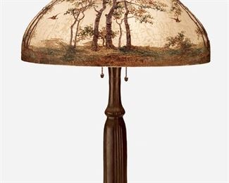 89
A Handel Obverse-Painted Glass Landscape Table Lamp
Circa 1921; Meriden, Connecticut
Shade signed: Handel Lamps / Pat'd. No. 979664 / Handel / 6868; Base signed: Handel
The domical, chipped ice and sand-finished glass shade molded with eight vertical lobes and with obverse-painted woodland scene with birds in flight in tones of green and brown against a frosted translucent ground on a three-light patinated metal base with a knopped inverted floriform column, electrified
Overall: 25" H x 18" Dia.
Estimate: $1,500 - $2,000