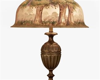 92
A Pairpoint Reverse-Painted Glass "Berkeley" Table Lamp
1907-1929; New Bedford, Massachusetts
Shade signed: The Pairpoint Corp'r. / H. Fisher; Base signed: Pairpoint / ["P" diamond monogram] / D 3037 / Made in U.S.A.
The chipped ice finished glass "Berkeley" shade with reverse-painted wooded landscape scene with chestnut trees in shades of green, blue, and yellow and polychrome flowers on a two-light patinated and gilt-bronze base with fluted urn-form column raised on an octagonal foot, electrified
Overall: 21" H x 15.75" Dia.
Estimate: $1,000 - $1,500