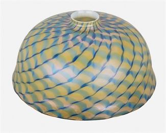 96
A Tiffany-Style Art Glass Lamp Shade
First-half 20th Century
The domical Tiffany-style art glass lamp shade with blue and green swirl design and pink iridescence
5.5" H x 11.25" Dia.
Estimate: $400 - $600