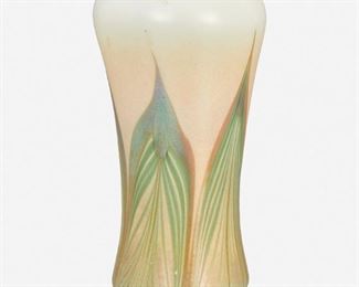 99
A Tiffany-Style Art Glass Vase
20th Century
The iridescent art glass vase with green and gold pulled feather motif on a cream ground with pinched foot, tapered body, and flared ruffled rim
7.75" H x 3.375" Dia.
Estimate: $400 - $600