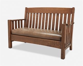 116
An Arts And Crafts Oak Settee
First-quarter 20th Century
The oak slat back settee with a through-tenon constructed straight top rail, thirteen slats, and paddle arms with slats over a light brown hide upholstered seat atop four square legs with a through-tenon constructed front seat rail
37.25" H x 60" W x 24" D
Estimate: $800 - $1,200