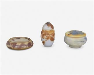136
Three Art Nouveau Cameo Glass Table Items
Late 19th/early 20th Century
Two signed: Galle; One signed indistinctly
Each acid-etched cameo glass, comprising one powder jar cut from blue to yellow and clear frost with blueberry motif, one Galle "Pine Needle" lidded box cut from amber to light blue frost, and one Galle "Fuchsia" dish cut from purple to light yellow frost, 3 pieces
Largest: 3.25" H x 4.5" Dia.; Smallest: 5" H x 3" Dia.
Estimate: $700 - $900