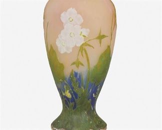 143
A Daum Vitrified Cameo Glass And Silver Mounted Vase
Late 19th/early 20th Century; Nancy, France
Signed: Daum Nancy [Croix de Lorraine]; Further marked for 950 silver with obus export hallmark
The vitrified and acid-etched cameo glass baluster-form vase cut from green and white to pink and blue with floral motif and fitted with silver beaded rim and foot decorated with high relief oak leaves and acorns
8.5" H x 4" W x 3.75" D
Estimate: $800 - $1,200
