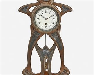 166
An Art Nouveau Patinated Metal Clock
Late 19th/early 20th Century
Movement marked: France / 1798 / 9 2
The clock with a white painted metal dial, black Arabic numeral hour markers, minute track, and single-train movement enclosed in a gadrooned and beaded bezel set in a free-form Art Nouveau patinated metal case with black cold painted low relief foliate motifs raised overall on a red marble base
17.25" H x 9.5" W x 6.5" D
Estimate: $400 - $600