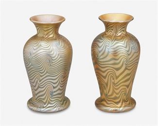 167
A Pair Of Loetz-Style Art Glass Vases
20th Century
Each iridescent gold and blue Loetz Phaenomen-style glass vase with urn-form body, flared neck, and wide foot, 2 pieces
Each: 7" H x 3.625" Dia.
Estimate: $400 - $600