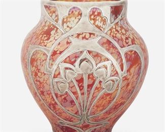 168
An Art Nouveau Loetz-Style Sterling Silver Overlay Vase
Late 19th/early 20th Century
Marked: Sterling
The iridescent red and yellow oil spot glass vase with wide-shouldered body and sterling silver foliate motif overlay
6" H x 5.5" Dia.
17.475 gross oz. troy approximately
Estimate: $400 - $600