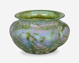 169
A Loetz-Style Art Glass Centerpiece Vase
Late 19th/early 20th Century
The iridescent green Loetz Crete Pampas-style centerpiece vase with squat lobed body and flared lip
5.5" H x 10.25" Dia.
Estimate: $500 - $700