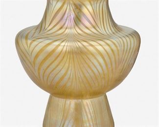170
A Loetz Phaenomen Glass Vase
Late 19th/early 20th Century
Signed: Loetz / Austria
The iridescent gold Phaenomen glass vase with pulled feather motif, wide-shouldered body, flared lip, and tapered foot
8.25" H x 7.125" Dia.
Estimate: $500 - $700