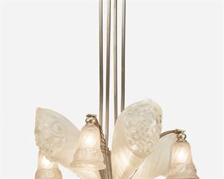 173
A Schneider Art Deco Frosted Glass Chandelier
Second-quarter 20th Century
Signed: Schneider / France / 1108
The eight-light chromed metal chandelier with geometric canopy, square columns, four backlit frosted and molded glass floral bouquet-form panels, and four geometric patterned arching arms issuing drop pendants with frosted and molded glass shades with cornucopia motif, electrified
36" H x 24" Dia.
Estimate: $800 - $1,200