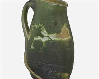 185
A Legras Cameo Glass Landscape Pitcher
Late 19th/early 20th Century
Signed: Legras
The acid-etched cameo glass pitcher cut from dark green to light green with wooded landscape scene and naturalistic vine handle
8.25" H x 6" W x 3.5" D
Estimate: $400 - $600