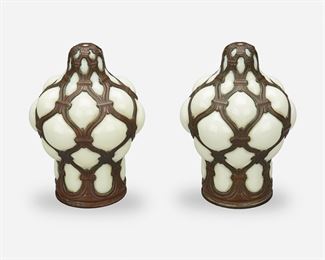 192
A Pair Of Spanish Revival-Style Bronze Caged Glass Lamp Shades
First-quarter 20th Century
Each bulbous shade of pale yellow blown glass in a Moroccan trellis patterned patinated bronze cage, 2 pieces
Each: 7" H x 5" Dia.
Estimate: $400 - $600