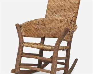 196
An Old Hickory Rocking Chair
First-quarter 20th Century
The original finish rocking chair with straight back and flared barrel-shaped arms with natural wood front and back posts raised on rockers joined by a box stretcher and finished with splint reed seat and back
40.5" H x 28" W x 35" D
Estimate: $500 - $700
