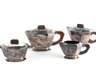 204
An Art Deco Silver Plate Tea And Coffee Service
Second-quarter 20th Century
Each stamped to base with maker's mark
Comprising one coffee pot, one teapot, one sugar bowl, and one cream jug with wood handles, 4 pieces
Larger: 5.75" H x 9" W x 4.5" D; Smaller: 3.25" H x 6.25" W x 3" D
Estimate: $400 - $600