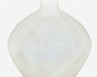 209
A René Lalique "Plumes" Vase
Circa 1920
Signed: R. Lalique
Designed 1920, model no. 944, the opalescent glass vase with a short neck over a globular body decorated with a swirled feather motif
8.5" H x 8.5" Dia.
Estimate: $500 - $700