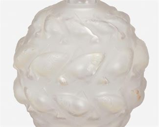 210
A René Lalique "Camaret" Vase
Circa 1928
Signed: R. Lalique / France / No. 1010
Designed 1928, the frosted glass camaret vase with four rows of alternating stylized fish on a spherical body
5.5" H x 5.125" Dia.
Estimate: $500 - $700