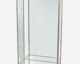 227
A Metal Mounted Glass Vitrine
Second-quarter 20th Century
The silvered metal mounted glass vitrine with mirrored interior fitted with two shelves and raised overall on four toupie feet
71.5" H x 36.5" W x 14.375" D
Estimate: $800 - $1,200