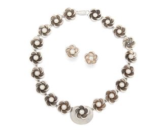 232
A Set Of William Spratling Silver Jewelry
1940-1946, First Design Period; Taxco, Mexico
Necklace stamped for William Spratling; Further stamped: Made in Mexico; Earrings attributed to William Spratling
A flower link necklace with matching screw back earrings, 3 pieces
Necklace: 18.50" L x 0.75" H; Earrings: 0.75"
83.5 grams
Estimate: $800 - $1,200