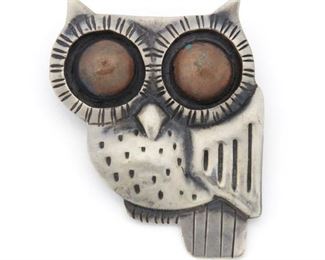 242
A William Spratling Silver And Copper Brooch
1940-1946, First Design Period; Taxco, Mexico
Stamped for William Spratling; Further stamped: Made in Mexico / Silver
A stylized owl brooch with two copper eyes
2" H x 1.75" W
26.5 grams
Estimate: $400 - $600