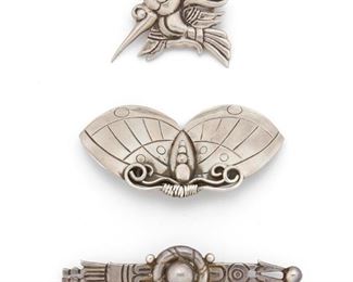 241
A Group Of William Spratling Silver Brooches
1933-1939 and 1940-1946, First Design Period; Taxco, Mexico
Each stamped for William Spratling: Others variously stamped for: Made in Mexico / Silver / Taxco / 980 / Sterling
A group of three whimsical brooches, 3 pieces
Moth brooch: 2.75" W x 1.50" H
42.5 grams
Estimate: $500 - $700