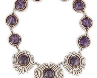 253
A Los Castillo Amethyst Lotus Necklace
Third-quarter 20th Century; Taxco, Mexico
Stamped: Los Castillo / Taxco / Eagle 15 / Sterling / Made en Mexico / 298
A necklace with eleven cabochon amethysts set into a stylized lotus flower silver backing
16" L x 2.75" H
139.6 grams
Estimate: $800 - $1,200