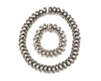 255
A Set Of Los Castillo Jewelry
1940; Taxco, Mexico
Each stamped: Los Castillo / Taxco / Eagle #15 / 380
Including a necklace and bracelet, designed with stylized curls with ball joints, 2 pieces
Necklace: 16.50" L x 0.75" W; Bracelet: 8" L x 0.75" W
239 grams
Estimate: $700 - $900